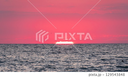 Beautiful red and orange sunrise over the sea. Beautiful red and orange sunrise over the sea. 129543848