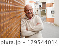 Elderly Spanish Man Standing by a Wall and Smiling 129544014