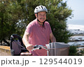 Elderly Man with Mustache and Helmet Riding a Bicycle 129544019