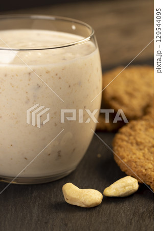 a field with wheat during ripening in the summer, a beautiful field with green and yellow wheat, against the background 129544095