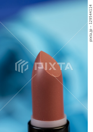 new lipstick for makeup, new dull red women's lipstick for lips, closeup new lipstick for makeup, new dull red women's lipstick for lips, closeup 129544114