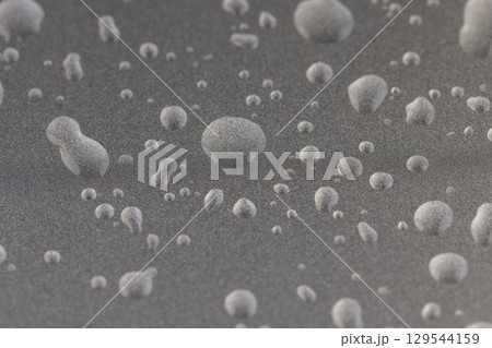 smooth silver-colored metal surface covered with drops of pure water, wet silver-colored metal painted to protect aluminum alloy and metals 129544159