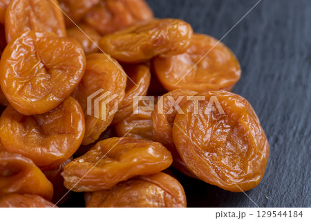 dried apricots from small apricots are orange in color, dehydrated in the sun and without seeds, closeup dried apricots from small apricots are orange in color, dehydrated in the sun and without seeds, closeup 129544184