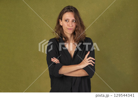 Pensive woman with crossed arms Pensive woman with crossed arms 129544341