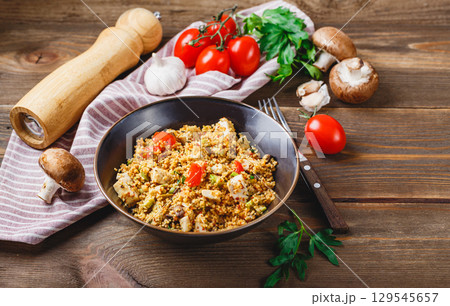 Couscous with turkey, tomatoes, champignon mushrooms and avocado. 129545657