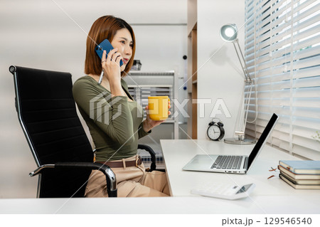 women talk mobile phones update tasks with milestones progress planning while working on laptop computers, online business, teleworking concept. women talk mobile phones update tasks with milestones progress planning while working on laptop computers, online business, teleworking concept. 129546540