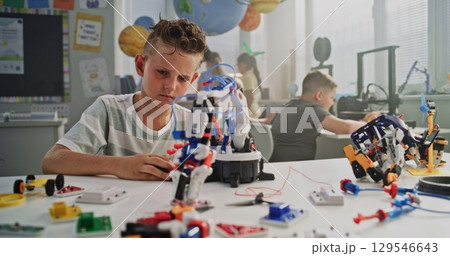Primary School Student Studying Robotic Arm Model, Learning Science and Robotics Primary School Student Studying Robotic Arm Model, Learning Science and Robotics 129546643