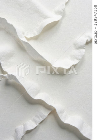 White fabric forming soft waves in vertical composition White fabric forming soft waves in vertical composition 129547359