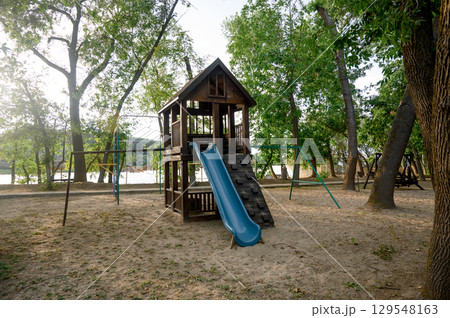 Children's playground with a view of the house and slide in the park Children's playground with a view of the house and slide in the park 129548163