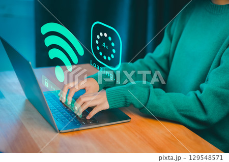 Person typing on a laptop with glowing Wi-Fi and loading graphics, symbolizing internet connectivity, online access, download digital business data form website, and slow data transfer progress. 129548571
