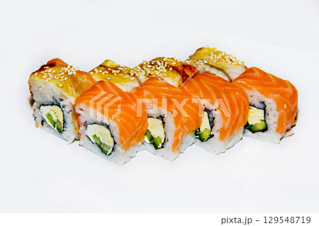 Freshly prepared sushi rolls featuring salmon and avocado served on a clean white plate 129548719