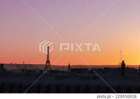 View of Paris and Eiffel Tower and rooftops from above. Beautiful sunset over Paris, France 129550816