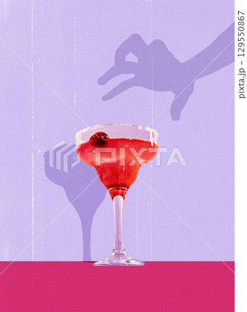 Colorful collage. Elegant red cocktail in margarita glass with cherry garnish and playful shadow on pastel background Colorful collage. Elegant red cocktail in margarita glass with cherry garnish and playful shadow on pastel background 129550867