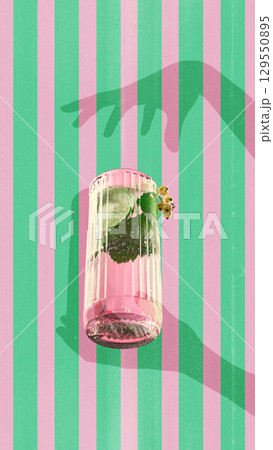 Modern collage. Tall glass of pink cocktail with mint and currants on striped pink and green background with hand shadows 129550895