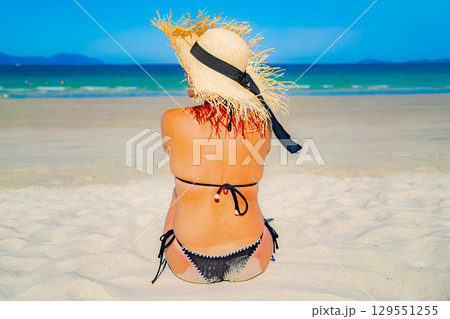Female image on the beach. 129551255