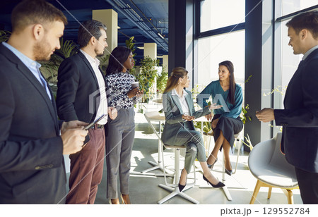 Office diverse business colleagues gathering in boardroom hall, female coworkers brainstorm Office diverse business colleagues gathering in boardroom hall, female coworkers brainstorm 129552784