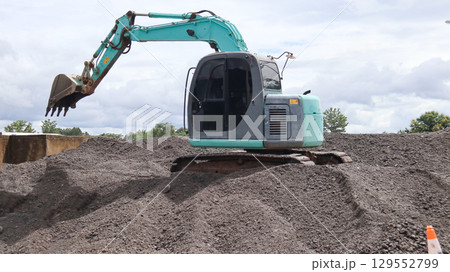 Excavator Digging Gravel Stones Close to the River Excavator Digging Gravel Stones Close to the River 129552799