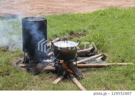 Zinc pot and container on a three legged wood stove 129552807