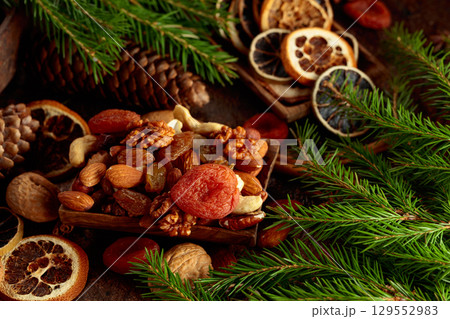 Dried fruits and nuts on a brown vintage background. 129552983