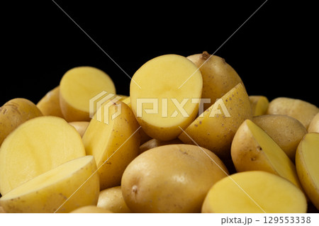 Fresh Raw Potatoes Cut In Half Close-Up Macro View. Fresh Raw Potatoes Cut In Half Close-Up Macro View. 129553338