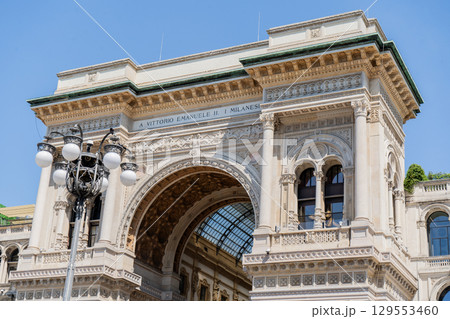 Entrance in Galleria Vittorio Emanuele II. Luxury shop sales and shopping mall brand world center in Europe 129553460