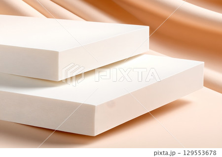 Stacked white rectangular blocks in a clean minimalist arrangement create a simple geometric display against a neutral backdrop 129553678
