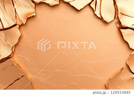Detailed close up of a cracked arid and weathered desert surface texture with a warm earthy color palette 129553695