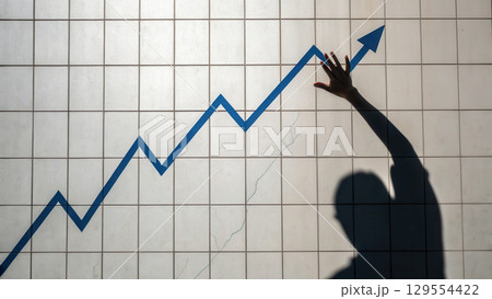image depicts hand reaching towards upward trending graph, symbolizing business growth and success 129554422