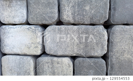 Close-up of gray cobblestone wall showing texture and pattern Close-up of gray cobblestone wall showing texture and pattern 129554553