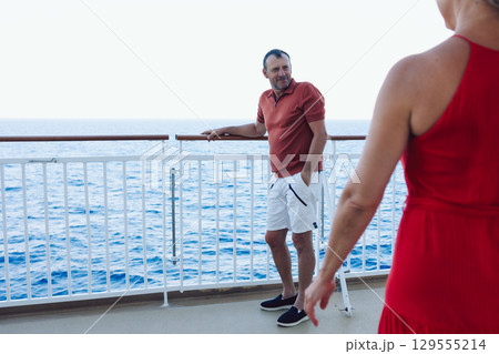 Married couple on cruise ship. Attractive couple on deck with cruise ship. High quality photo 129555214