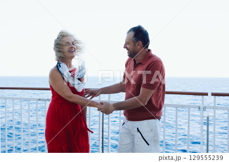 Couple in love on cruise ship. Man and woman in love enjoying their romantic vacation. High quality photo Couple in love on cruise ship. Man and woman in love enjoying their romantic vacation. High quality photo 129555239