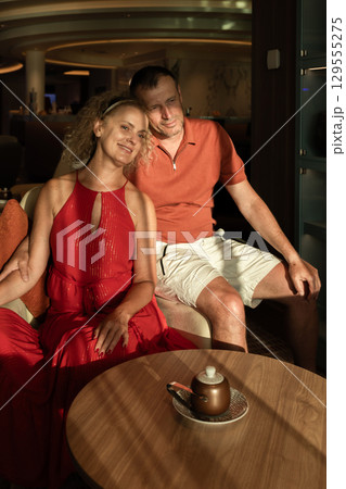 Couple in love on cruise ship. Man and woman in love enjoying their romantic vacation. Vertical photo. High quality photo 129555275