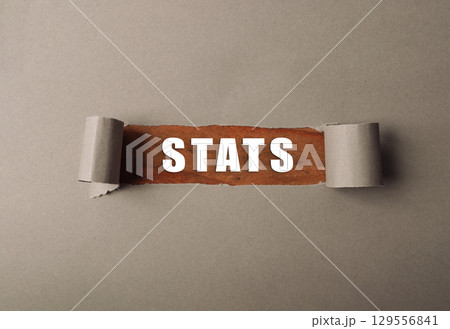Torn piece of paper with the word stats written on it 129556841