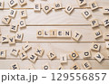 Jumble of wooden letters spell out the word client on a wooden surface 129556857