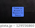 Blue sign that says There is always a reason to smile 129556860