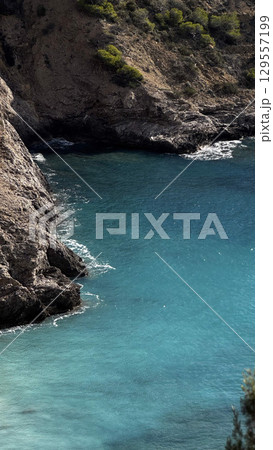 Rocky cliffs of Ibiza in Mediterranean 129557199