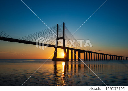 Vasco da Gamma road bridge in Portuguese capital Lisbon at sunrise. Vasco da Gamma road bridge in Portuguese capital Lisbon at sunrise. 129557395