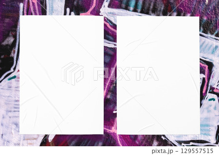 colorful urban wall texture with two wrinkled glued poster templates 129557515