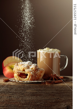 Vienna strudel and caffe latte on an old wooden table. Vienna strudel and caffe latte on an old wooden table. 129557531