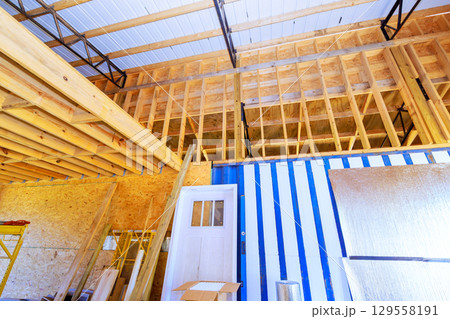Interior view construction site showing wooden framing storage area in progress building 129558191