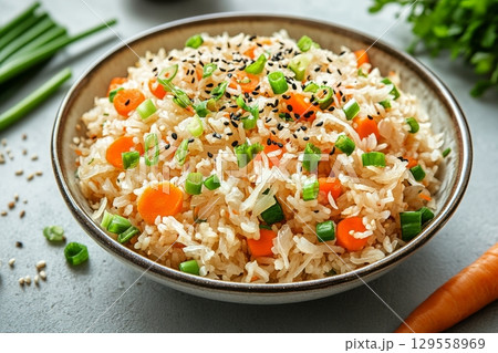 Delicious Vegetable Fried Rice Served in a Bowl on a Light Countertop. 129558969