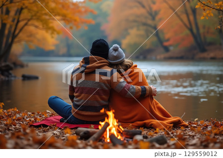 Couple embracing by a lake. 129559012