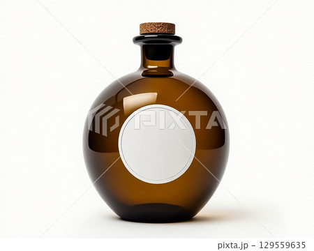 Elegant amber glass bottle with a cork top and blank label for custom branding or gifts 129559635
