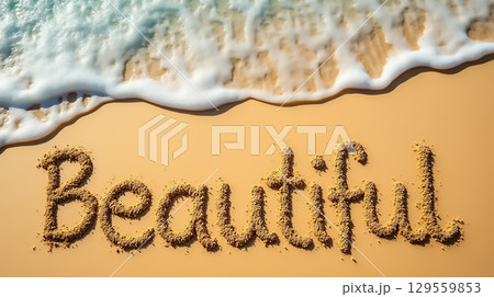 Writing beautiful messages in the sand by the ocean during a sunny day 129559853