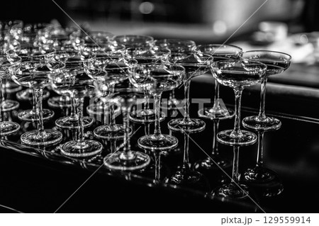 Close up Empty wine glasses on dark background, close up. Close up Empty wine glasses on dark background, close up. 129559914