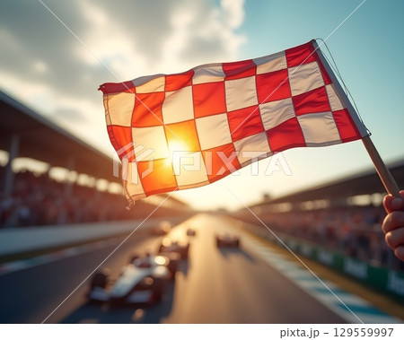 Sunset at the racetrack as the checkered flag signals the end of an exciting race 129559997