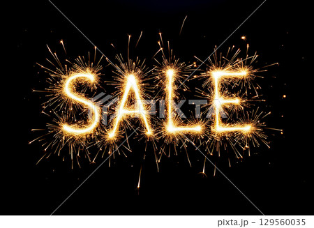 Exciting sale announcement created with sparklers at night event for promotional purposes 129560035