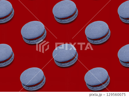Pattern blueberry blue macaroon brownie on red background Pattern blueberry blue macaroon brownie on red background 129560075