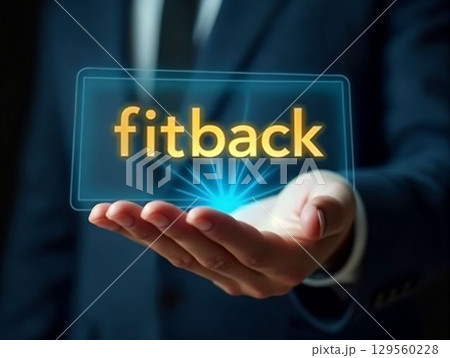 Hand holding a holographic display showcasing the word Fitback at a professional business event 129560228