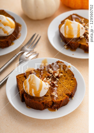 Pumpkin bread freshly baked topped with whipped cream, Thanksgiving dessert 129560702